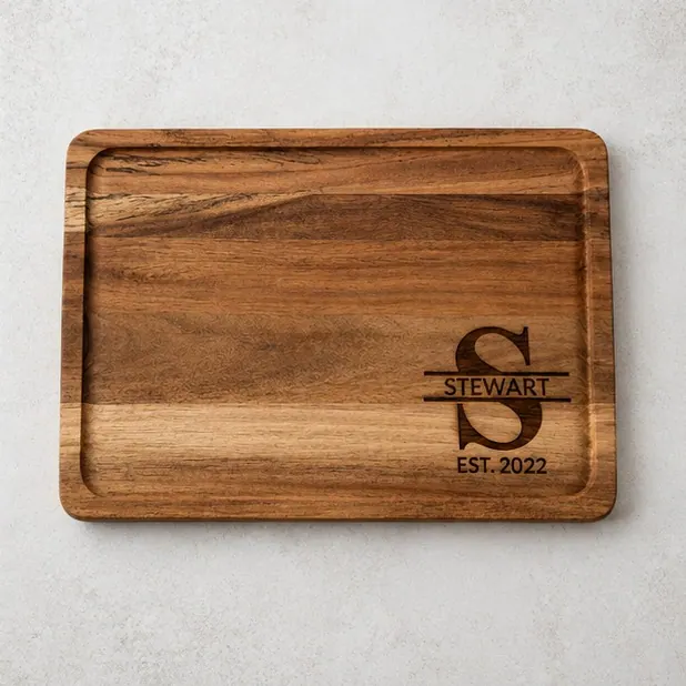 A split monogram board, the large initial behind the surname