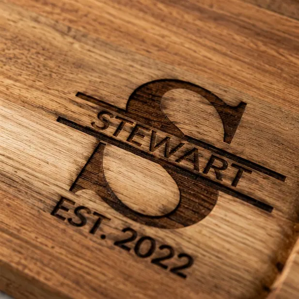 An acacia board with a split monogram, the grain doing the work