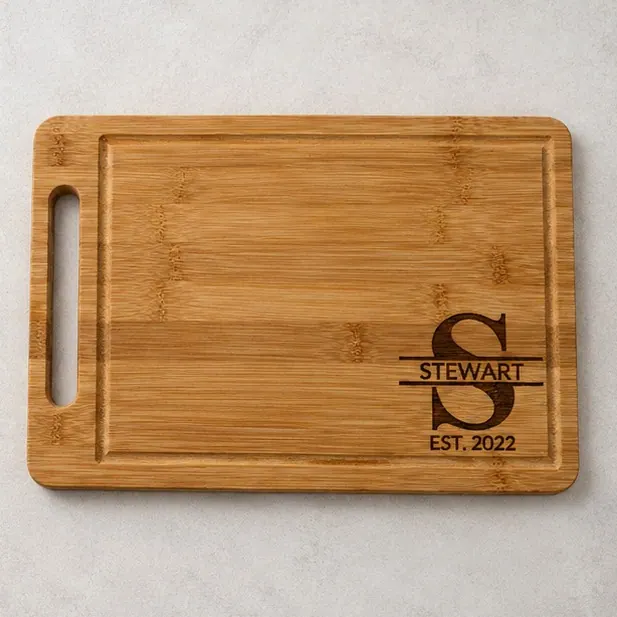 A split monogram bamboo board with the family initial and surname