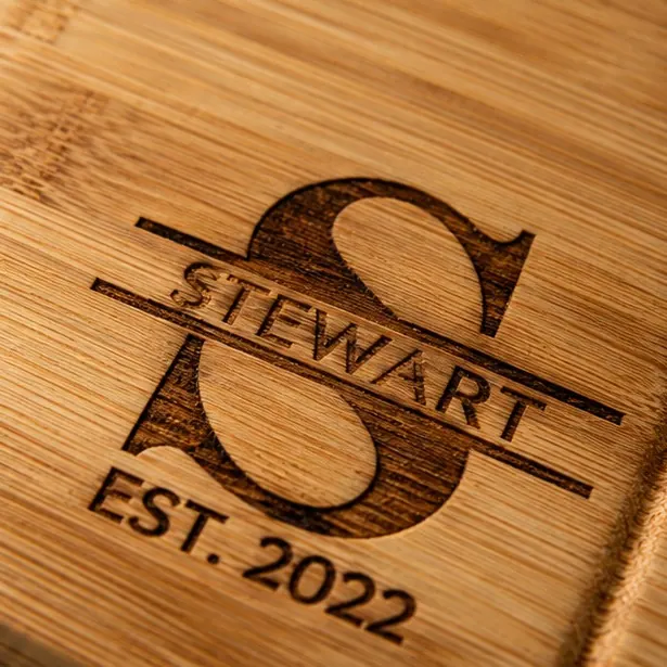 A bamboo split-monogram board with the couple's initial and surname